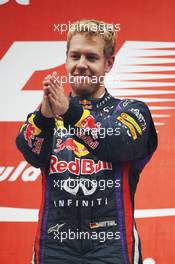 Race winner and World Champion Sebastian Vettel (GER) Red Bull Racing celebrates on the podium. 27.10.2013. Formula 1 World Championship, Rd 16, Indian Grand Prix, New Delhi, India, Race Day.