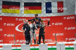 The podium (L to R): Adrian Newey (GBR) Red Bull Racing Chief Technical Officer; Nico Rosberg (GER) Mercedes AMG F1, second; Sebastian Vettel (GER) Red Bull Racing, race winner and World Champion; Romain Grosjean (FRA) Lotus F1 Team, third. 27.10.2013. Formula 1 World Championship, Rd 16, Indian Grand Prix, New Delhi, India, Race Day.