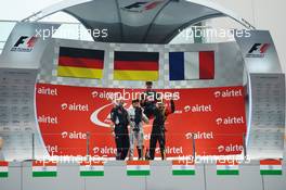 The podium (L to R): Adrian Newey (GBR) Red Bull Racing Chief Technical Officer; Nico Rosberg (GER) Mercedes AMG F1, second; Sebastian Vettel (GER) Red Bull Racing, race winner and World Champion; Romain Grosjean (FRA) Lotus F1 Team, third. 27.10.2013. Formula 1 World Championship, Rd 16, Indian Grand Prix, New Delhi, India, Race Day.