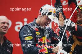 Race winner and World Champion Sebastian Vettel (GER) Red Bull Racing celebrates with the champagne on the podium. 27.10.2013. Formula 1 World Championship, Rd 16, Indian Grand Prix, New Delhi, India, Race Day.