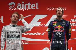 1st place a 2013 World champion Sebastian Vettel (GER) Red Bull Racing and 2nd place Nico Rosberg (GER) Mercedes AMG F1 W04. 27.10.2013. Formula 1 World Championship, Rd 16, Indian Grand Prix, New Delhi, India, Race Day.