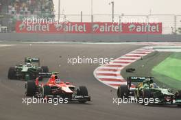 Charles Pic (FRA) Caterham CT03, Max Chilton (GBR) Marussia F1 Team MR02 and Giedo van der Garde (NLD) Caterham CT03 involved in contact at the start of the race. 27.10.2013. Formula 1 World Championship, Rd 16, Indian Grand Prix, New Delhi, India, Race Day.
