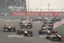 Kimi Raikkonen (FIN) Lotus F1 E21 leads Mark Webber (AUS) Red Bull Racing RB9, Nico Hulkenberg (GER) Sauber C32 and Fernando Alonso (ESP) Ferrari F138 at the start of the race. 27.10.2013. Formula 1 World Championship, Rd 16, Indian Grand Prix, New Delhi, India, Race Day.