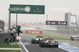 Paul di Resta (GBR) Sahara Force India VJM06 leads Fernando Alonso (ESP) Ferrari F138 out of the pits. 27.10.2013. Formula 1 World Championship, Rd 16, Indian Grand Prix, New Delhi, India, Race Day.