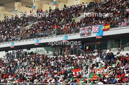 Fans in the grandstand. 27.10.2013. Formula 1 World Championship, Rd 16, Indian Grand Prix, New Delhi, India, Race Day.