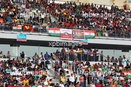 Fans in the grandstand. 27.10.2013. Formula 1 World Championship, Rd 16, Indian Grand Prix, New Delhi, India, Race Day.