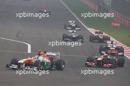 Adrian Sutil (GER) Sahara Force India VJM06 leads Jenson Button (GBR) McLaren MP4-28. 27.10.2013. Formula 1 World Championship, Rd 16, Indian Grand Prix, New Delhi, India, Race Day.
