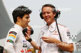 (L to R): Sergio Perez (MEX) McLaren with Sam Michael (AUS) McLaren Sporting Director. 26.10.2013. Formula 1 World Championship, Rd 16, Indian Grand Prix, New Delhi, India, Qualifying Day.