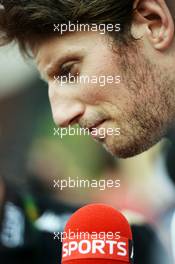Romain Grosjean (FRA) Lotus F1 Team with the media. 26.10.2013. Formula 1 World Championship, Rd 16, Indian Grand Prix, New Delhi, India, Qualifying Day.