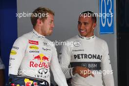 (L to R): Pole sitter Sebastian Vettel (GER) Red Bull Racing with Lewis Hamilton (GBR) Mercedes AMG F1 in parc ferme. 26.10.2013. Formula 1 World Championship, Rd 16, Indian Grand Prix, New Delhi, India, Qualifying Day.
