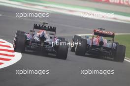 (L to R): Mark Webber (AUS) Red Bull Racing RB9 and Jean-Eric Vergne (FRA) Scuderia Toro Rosso STR8 leave the pits. 26.10.2013. Formula 1 World Championship, Rd 16, Indian Grand Prix, New Delhi, India, Qualifying Day.