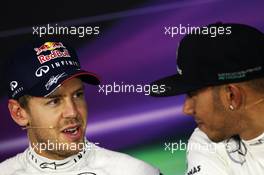 (L to R): Sebastian Vettel (GER) Red Bull Racing with Lewis Hamilton (GBR) Mercedes AMG F1 in the FIA Press Conference. 26.10.2013. Formula 1 World Championship, Rd 16, Indian Grand Prix, New Delhi, India, Qualifying Day.