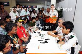 (L to R): Dr. Vijay Mallya (IND) Sahara Force India F1 Team Owner and Jehan Daruvala (IND) Sahara Force India Academy Driver, winner of the British KF3 Karting Championship, with the media. 26.10.2013. Formula 1 World Championship, Rd 16, Indian Grand Prix, New Delhi, India, Qualifying Day.