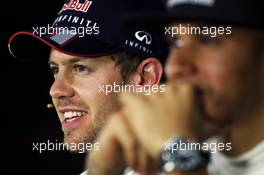 (L to R): Sebastian Vettel (GER) Red Bull Racing with Lewis Hamilton (GBR) Mercedes AMG F1 in the FIA Press Conference. 26.10.2013. Formula 1 World Championship, Rd 16, Indian Grand Prix, New Delhi, India, Qualifying Day.