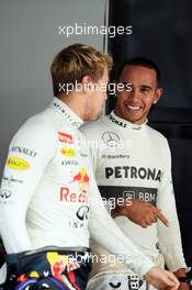 (L to R): pole sitter Sebastian Vettel (GER) Red Bull Racing with Lewis Hamilton (GBR) Mercedes AMG F1. 26.10.2013. Formula 1 World Championship, Rd 16, Indian Grand Prix, New Delhi, India, Qualifying Day.