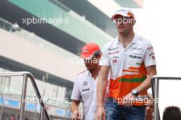 Paul di Resta (GBR) Sahara Force India F1 and Jenson Button (GBR) McLaren on the drivers parade. 27.10.2013. Formula 1 World Championship, Rd 16, Indian Grand Prix, New Delhi, India, Race Day.