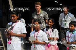 Local children with the Mercedes AMG F1 team. 24.10.2013. Formula 1 World Championship, Rd 16, Indian Grand Prix, New Delhi, India, Preparation Day.