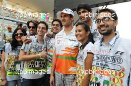 Adrian Sutil (GER) Sahara Force India F1 with circuit staff. 24.10.2013. Formula 1 World Championship, Rd 16, Indian Grand Prix, New Delhi, India, Preparation Day.