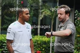 (L to R): Lewis Hamilton (GBR) Mercedes AMG F1 with Bradley Lord (GBR) Mercedes AMG F1 Communications Manager. 24.10.2013. Formula 1 World Championship, Rd 16, Indian Grand Prix, New Delhi, India, Preparation Day.