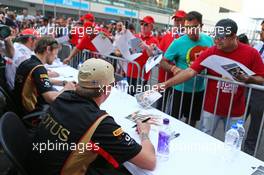Kimi Raikkonen (FIN) Lotus F1 Team signs autographs for the fans. 24.10.2013. Formula 1 World Championship, Rd 16, Indian Grand Prix, New Delhi, India, Preparation Day.