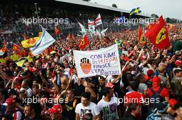 Fans celebrate under the podium with a banner for Kimi Raikkonen (FIN) Lotus F1 Team. 08.09.2013. Formula 1 World Championship, Rd 12, Italian Grand Prix, Monza, Italy, Race Day.