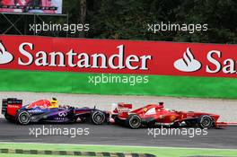 Fernando Alonso (ESP) Ferrari F138 and Mark Webber (AUS) Red Bull Racing RB9 battle for position. 08.09.2013. Formula 1 World Championship, Rd 12, Italian Grand Prix, Monza, Italy, Race Day.