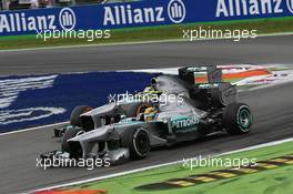 Lewis Hamilton (GBR) Mercedes AMG F1 W04 and team mate Nico Rosberg (GER) Mercedes AMG F1 W04 battle for position. 08.09.2013. Formula 1 World Championship, Rd 12, Italian Grand Prix, Monza, Italy, Race Day.