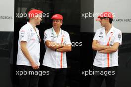 McLaren team members in retro kit celebrating 50 years as a constructor. 08.09.2013. Formula 1 World Championship, Rd 12, Italian Grand Prix, Monza, Italy, Race Day.