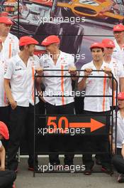 (L to R): Jenson Button (GBR) McLaren; Martin Whitmarsh (GBR) McLaren Chief Executive Officer; and Sergio Perez (MEX) McLaren celebrate 50 years of McLaren as a constructor. 08.09.2013. Formula 1 World Championship, Rd 12, Italian Grand Prix, Monza, Italy, Race Day.