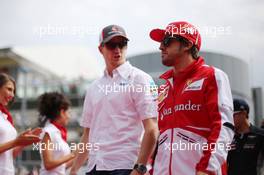 (L to R): Nico Hulkenberg (GER) Sauber and Fernando Alonso (ESP) Ferrari on the drivers parade. 08.09.2013. Formula 1 World Championship, Rd 12, Italian Grand Prix, Monza, Italy, Race Day.