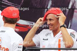 (L to R): Jenson Button (GBR) McLaren and Martin Whitmarsh (GBR) McLaren Chief Executive Officer celebrate 50 years of McLaren as a constructor. 08.09.2013. Formula 1 World Championship, Rd 12, Italian Grand Prix, Monza, Italy, Race Day.