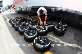 McLaren mechanic with Pirelli tyres. 05.09.2013. Formula 1 World Championship, Rd 12, Italian Grand Prix, Monza, Italy, Preparation Day.