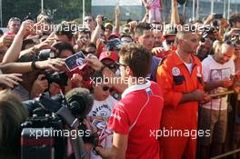 Jules Bianchi (FRA) Marussia F1 Team signs autographs for the fans. 05.09.2013. Formula 1 World Championship, Rd 12, Italian Grand Prix, Monza, Italy, Preparation Day.