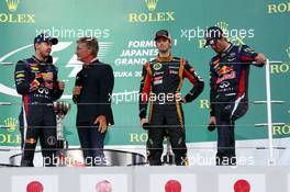 (L to R): race winner Sebastian Vettel (GER) Red Bull Racing on the podium with Eddie Jordan (IRE) BBC Television Pundit, third placed Romain Grosjean (FRA) Lotus F1 Team, and second placed Mark Webber (AUS) Red Bull Racing. 13.10.2013. Formula 1 World Championship, Rd 15, Japanese Grand Prix, Suzuka, Japan, Race Day.