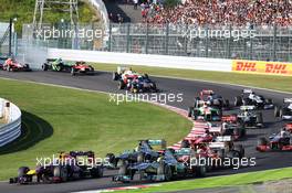 Lewis Hamilton (GBR) Mercedes AMG F1 W04 slows with a puncture after contact at the start of the race with Sebastian Vettel (GER) Red Bull Racing RB9, as Jules Bianchi (FRA) Marussia F1 Team MR02 and Giedo van der Garde (NLD) Caterham CT03 crash in the background. 13.10.2013. Formula 1 World Championship, Rd 15, Japanese Grand Prix, Suzuka, Japan, Race Day.