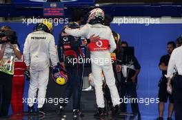 Jenson Button (GBR) McLaren (Right) congratulates Mark Webber (AUS) Red Bull Racing (Centre) on his pole position in parc ferme. 12.10.2013. Formula 1 World Championship, Rd 15, Japanese Grand Prix, Suzuka, Japan, Qualifying Day.