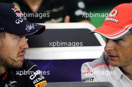 (L to R): Sebastian Vettel (GER) Red Bull Racing and Jenson Button (GBR) McLaren in the FIA Press Conference. 10.10.2013. Formula 1 World Championship, Rd 15, Japanese Grand Prix, Suzuka, Japan, Preparation Day.