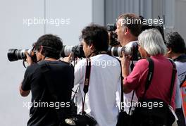 Photographer in the paddock  10.10.2013. Formula 1 World Championship, Rd 15, Japanese Grand Prix, Suzuka, Japan, Preparation Day.