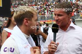 (L to R): Sebastian Vettel (GER) Red Bull Racing with David Coulthard (GBR) Red Bull Racing and Scuderia Toro Advisor / BBC Television Commentator on the grid. 06.10.2013. Formula 1 World Championship, Rd 14, Korean Grand Prix, Yeongam, South Korea, Race Day.