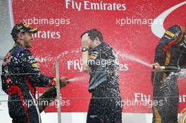 The podium (L to R): Race winner Sebastian Vettel (GER) Red Bull Racing celebrates with the champagne with Tim Malyon (GBR) Red Bull Racing Performance Engineer. 06.10.2013. Formula 1 World Championship, Rd 14, Korean Grand Prix, Yeongam, South Korea, Race Day.