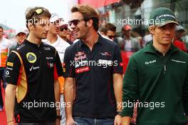 (L to R): Romain Grosjean (FRA) Lotus F1 Team with Jean-Eric Vergne (FRA) Scuderia Toro Rosso and Charles Pic (FRA) Caterham on the drivers parade. 06.10.2013. Formula 1 World Championship, Rd 14, Korean Grand Prix, Yeongam, South Korea, Race Day.