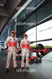 (L to R): Jenson Button (GBR) McLaren and team mate Sergio Perez (MEX) McLaren with the new McLaren MP4-28. 31.01.2013. McLaren MP4-28 Launch, McLaren Technology Centre, Woking, England.