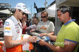 Adrian Sutil (GER) Sahara Force India F1 signs autographs for the fans. 22.05.2013. Formula 1 World Championship, Rd 6, Monaco Grand Prix, Monte Carlo, Monaco, Preparation Day.