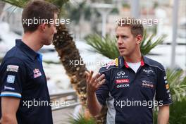 Sebastian Vettel (GER) Red Bull Racing with Sebastien Ogier (FRA) Rally Driver. 22.05.2013. Formula 1 World Championship, Rd 6, Monaco Grand Prix, Monte Carlo, Monaco, Preparation Day.