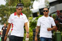 (L to R): Rodolfo Gonzalez (VEN) Marussia F1 Team Reserve Driver with Lewis Hamilton (GBR) Mercedes AMG F1. 22.03.2013. Formula 1 World Championship, Rd 2, Malaysian Grand Prix, Sepang, Malaysia, Friday.