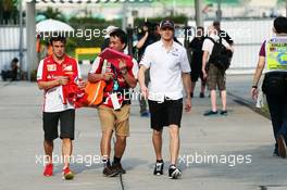 Fernando Alonso (ESP) Ferrari and Nico Hulkenberg (GER) Sauber with a fan. 22.03.2013. Formula 1 World Championship, Rd 2, Malaysian Grand Prix, Sepang, Malaysia, Friday.