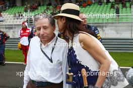 Jean Todt (FRA) FIA President with Michelle Yeoh (MAL) on the grid. 24.03.2013. Formula 1 World Championship, Rd 2, Malaysian Grand Prix, Sepang, Malaysia, Sunday.