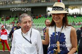 Jean Todt (FRA) FIA President with Michelle Yeoh (MAL) on the grid. 24.03.2013. Formula 1 World Championship, Rd 2, Malaysian Grand Prix, Sepang, Malaysia, Sunday.