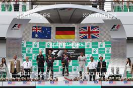 The podium (L to R): Mark Webber (AUS) Red Bull Racing, second; Sebastian Vettel (GER) Red Bull Racing, race winner; Lewis Hamilton (GBR) Mercedes AMG F1, third. 24.03.2013. Formula 1 World Championship, Rd 2, Malaysian Grand Prix, Sepang, Malaysia, Sunday.