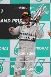 Lewis Hamilton (GBR) Mercedes AMG F1 celebrates his third position on the podium. 24.03.2013. Formula 1 World Championship, Rd 2, Malaysian Grand Prix, Sepang, Malaysia, Sunday.